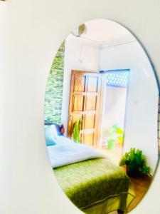 a bedroom with a bed and a mirror at Shikos Place in Watamu