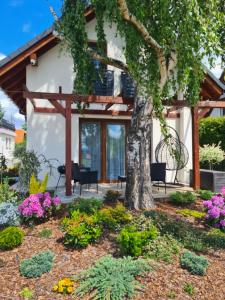 a garden in front of a house with a tree at Lawendowy Domek Boutique Resort, Zator, Przeciszów in Zator