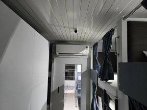 a hallway leading to a room with a ceiling at Aqua Marol Dormitory in Mumbai