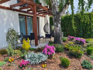 a garden with flowers in front of a house at Lawendowy Domek Boutique Resort, Zator, Przeciszów in Zator +96 photos