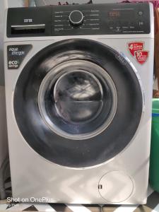 a white washing machine sitting on top of a counter at Aqua Marol Dormitory in Mumbai +10 photos