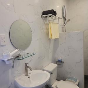 a white bathroom with a sink and a mirror at TuloMir #A 뚤로미르 행복한 4인실 in Moalboal +29 photos