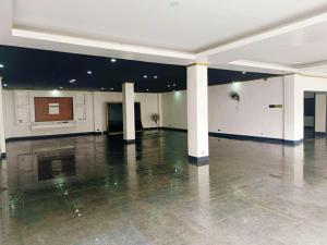 an empty room with a large room with pillars in a building at PNS Sports Hotel in Liliw