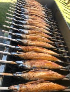 a row of sausages cooking on a grill at Apartmama Lipová in Lipova Lazne