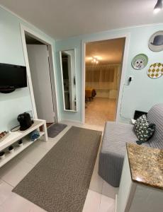a living room with a couch and a television at Luce di Stagno in Stagno