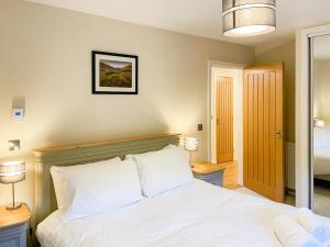 a bedroom with a large bed with white pillows at Glenview - Ukc6856 in Millton of Clova