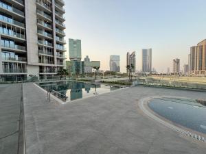 a swimming pool in the middle of a city at 1 Bedroom in Maryah Island by Central Stay 1 min to Cleveland, Galleria Mall and ADGM in Abu Dhabi