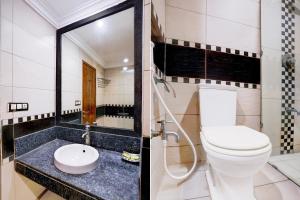 a bathroom with a toilet and a sink at Super Townhouse Bharuch Near Railway Station Formerly Hotel Kohinoor in Bharuch