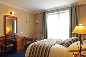 Postel nebo postele na pokoji v ubytování Fitzgeralds Hotel + 25 fotografií