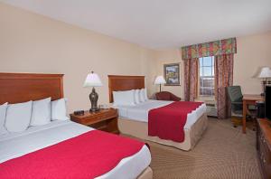 A bed or beds in a room at Ramada by Wyndham Sparta/At Speedway