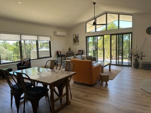 a living room with a table and a couch at Ernie's Acre in Watervale