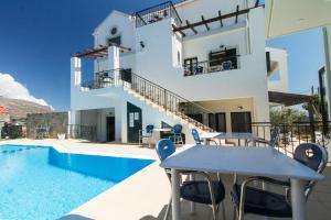 a villa with a swimming pool and a house at Olive Tree in Kissamos