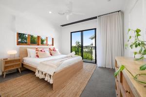 a bedroom with a bed and a large window at Inner City Townhouse in Brisbane