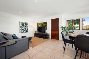 a living room with a couch and a table at Inner City Townhouse in Brisbane