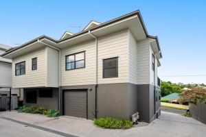 a large white house with a garage at Inner City Townhouse in Brisbane