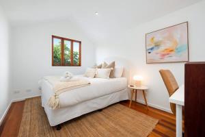 a white living room with a white couch and a window at Inner City Townhouse in Brisbane +23 photos