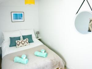 a bedroom with a bed with two pillows on it at The Chalet in Portreath +15 photos