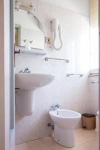 a bathroom with a sink and a toilet at Hotel Hamburg in Senigallia