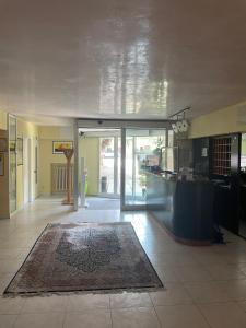 a large room with a lobby with a rug on the floor at Hotel La Terrazza in Porto San Giorgio