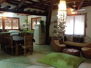 a kitchen and living room with a table and a couch at La Casa de Juan in Holbox Island