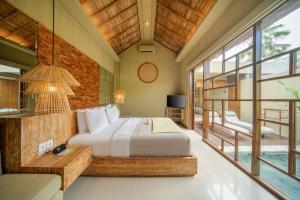 Postel nebo postele na pokoji v ubytování Manca Villa Canggu by Ini Vie Hospitality