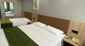 Ένα ή περισσότερα κρεβάτια σε δωμάτιο στο GreenTree Inn Wuhu Fangte Second Phase Nanxiang Wanshang Express Hotel