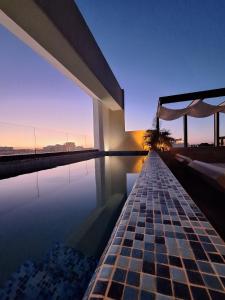 a view of a swimming pool in a building at George Luxury Condo in Playa del Carmen