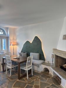 a living room with a couch and a table at Sea views - Marble Palace - 2 floors in Tinos