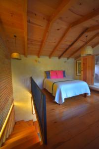 a bedroom with a bed in a wooden house at Las Casas Chiapas in San Cristóbal de Las Casas