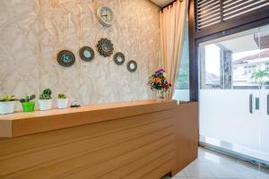 a restaurant with a counter with clocks on the wall at Collection O Padang near Mesjid Raya Syekh Ahmad Al-Minangkabawi formerly Hotel Surya Palace in Padang +49 photos
