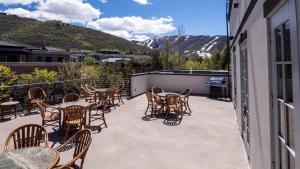 a patio with tables and chairs on a balcony at Park City Hostel in Park City