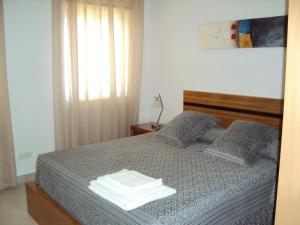 a bedroom with a bed with towels on it at Casa do Mosteiro de Refoios do Lima in Ponte de Lima