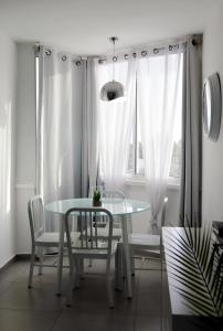 a dining room with a table and chairs and a window at Eilat Apartments - דירות נופש באילת in Eilat +5 photos