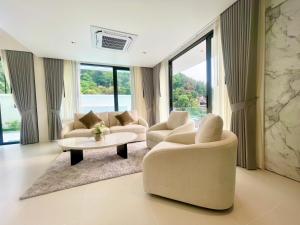 un soggiorno con due sedie e un tavolo di Mali Thai Villa - Just 5 minutes to Kata Beach a Kata Beach
