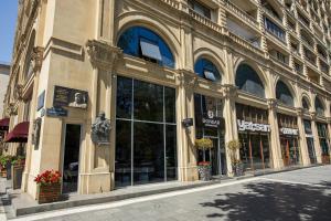 a store front of a building on a street at Dondar Hotel Formula 1 View in Baku