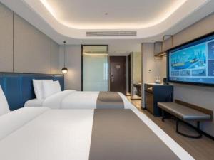 TV a/nebo společenská místnost v ubytování Yitel Collection Shenyang Imperial Palace Zhongjie Metro Station