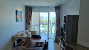 a living room with a couch and a table at Grandblue condominium 609 in Mae Pim