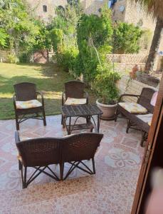 a group of chairs and tables on a patio at Sou Villa in El Alamein