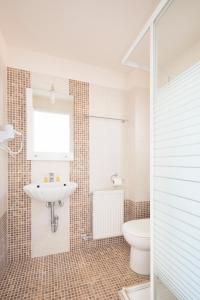 a bathroom with a sink and a toilet at Panorama Hotel in Platána