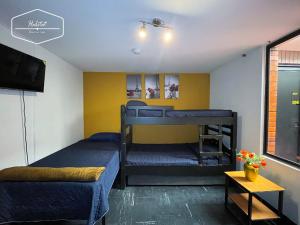Postel nebo postele na pokoji v ubytování Hotel Habitat Hospedaje