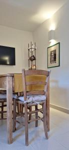 a wooden chair sitting in front of a table at Apartment C-MM09 in Bussi sul Tirino