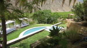 a swimming pool in a yard with a landscaping at Cabañas Elquimista in Pisco Elqui