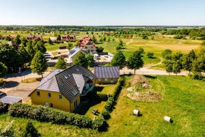 an aerial view of a house on a green field at One Putt Erdgeschoss in Göhren-Lebbin