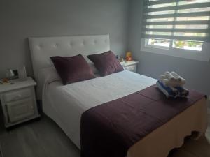 a bedroom with a bed with two stuffed animals on it at casa con piscina Comarruga in Comarruga +24 photos