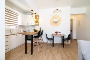 a kitchen and dining room with a table and chairs at Venetis Family House in Gouvia