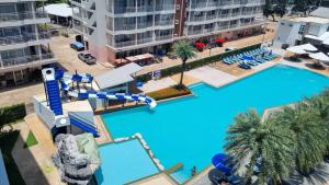 an overhead view of a pool with a water slide at Grandblue condominium 602 in Ban Tha Fat