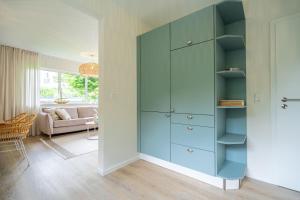 a blue cabinet in a room with a living room at Ferienhaus Strandnest in Ahlbeck +47 photos
