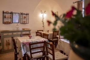 a dining room with two tables and chairs with flowers at Locanda del Gufo Civezza in Civezza