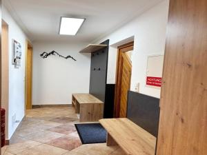 a hallway with benches and a sign on the wall at Apartment Maiskogel - directly on the ski slope in Kaprun