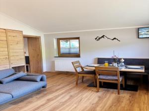 a living room with a table and a couch at Apartment Maiskogel - directly on the ski slope in Kaprun
